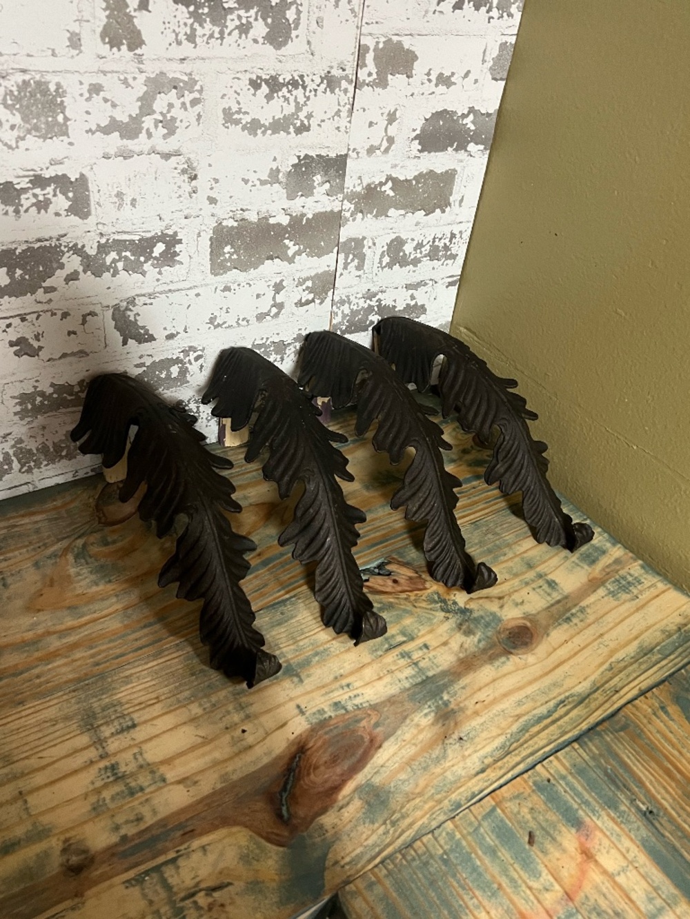 Cast iron leaf drapery holdback featuring a detailed, textured fern-like leaf